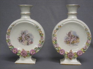 A pair of Edwardian pottery moon shaped vases with floral encrusted and cherub decoration, the base marked Forster & Son London, 15" (some chips to floral encrustation)