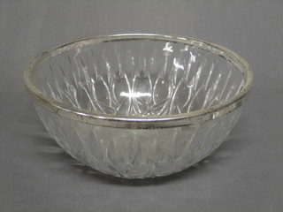 A circular glass bowl with silver plated rim 9" and a faience pottery plate decorated a bird (chip to rim) 9"