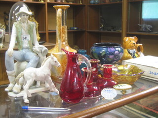 A porcelain figure of a seated gentleman with dog 13", a teapot and stand in the form of a teddybear, 4 red Venetian glass stub candlesticks 3 1/2" and a small collection of decorative items