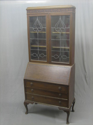A Chippendale style mahogany bureau bookcase, the upper section with blind fret work frieze, the interior fitted shelves enclosed by lead glazed panelled doors, the fall front revealing a well fitted interior above 3 long drawers, raised on cabriole supports 34" 