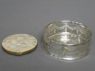 A Stratton compact with mother of pearl decoration and a circular pierced silver plated bottle coaster