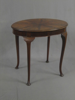 An oval Georgian style flame mahogany occasional table raised on cabriole supports 30"