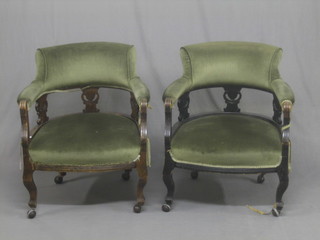 A pair of Edwardian tub back chairs upholstered in green material, raised on cabriole supports