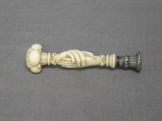 A Victorian seal in the form of 2 carved ivory clasped hands