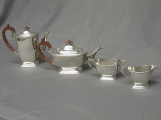 A 4 piece silver plated tea service comprising oval teapot, hotwater jug a twin handled sugar bowl and a milk jug