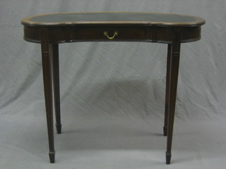 An Edwardian kidney shaped writing table fitted a drawer, raised on square tapering supports ending in spade feet 35"