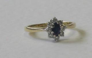 An 18ct yellow gold dress ring set an oval sapphire supported by diamonds