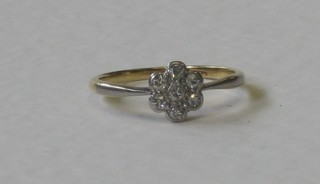 An 18ct gold cluster ring set diamonds