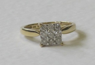 A 9ct gold square shaped dress ring set numerous diamonds