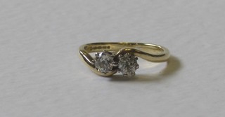 An 18ct gold dress ring set 2 circular cut diamonds