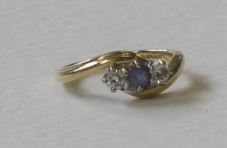 An 18ct gold dress ring set a sapphire and 2 diamonds