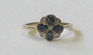 A 9ct gold dress ring set 4 oval cut sapphires supported by diamonds