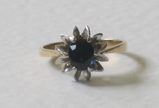 A lady's gold dress ring set a sapphire