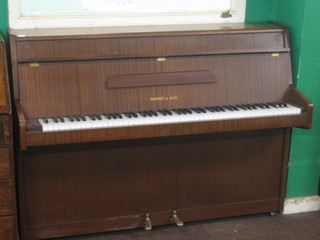 A modern upright piano forte by Barnes & Avis, contained in a mahogany finished case 54"
