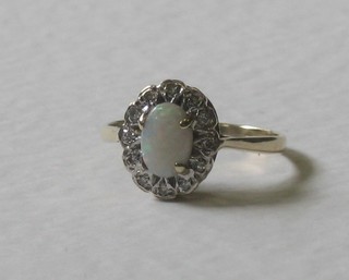 A gold dress ring set an oval cut opal supported by diamonds