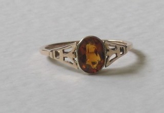A 9ct yellow gold dress ring set an oval amber coloured stone