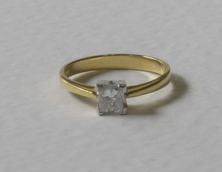 An 18ct yellow gold dress/engagement ring set a square cut solitaire diamond, approx 0.50ct