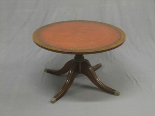 A circular Georgian style mahogany coffee with inset leather surface raised on a tripod base 32"
