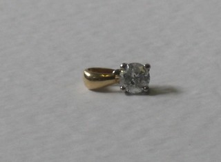A diamond solitaire pendant in an 18ct gold mount, approx 0.50ct