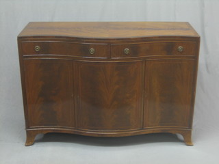 A Georgian style mahogany sideboard of serpentine outline fitted 2 long drawers above a triple cupboard, raised on splayed bracket feet 54"