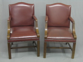 A pair of Georgian style mahogany library chairs upholstered in leather