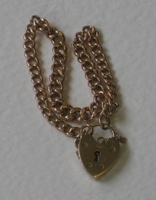 A 9ct gold curb link bracelet with heart shaped padlock