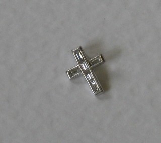 A small white gold Latin cross set diamonds