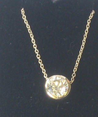 A diamond circular stud shaped pendant hung on a gold chain, approx 0.75ct