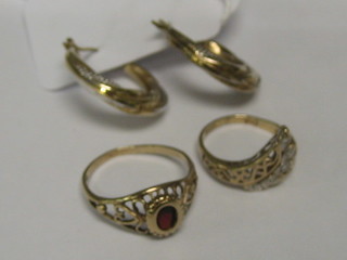 2 gold dress rings and a pair of hoop earrings
