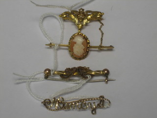 A gilt metal brooch and 3 others