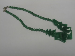 A string of jade coloured shaped beads