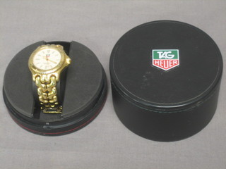 A gentleman's TAG wristwatch contained in a gilt metal case, boxed