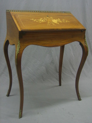 A 19th Century French inlaid mahogany bonheur du jour with brass three-quarter gallery and gilt metal mounts, the interior fitted a drawer above a well, raised on cabriole supports 26"
