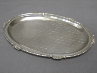 An oval Sterling tray with cast border 8"