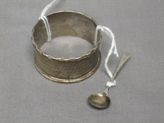 A silver napkin ring and a silver condiment spoon