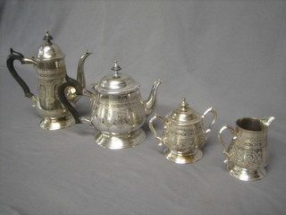 An engraved circular silver plated 4 piece tea service comprising teapot, hotwater jug, twin handled sugar bowl and cover and milk jug
