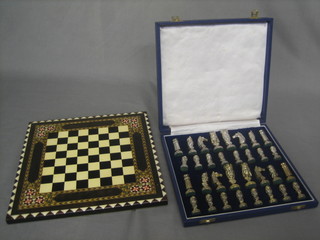 A modern silver and silver gilt chess set, complete with board