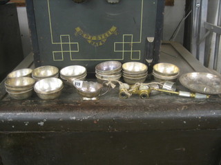 24 circular silver plated hotelware sugar bowls, a silver plated sauce boat, a dish, a pair of opera glasses (f) and 3 napkin rings