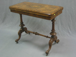A Victorian inlaid walnut card table, raised on turned columns united by an H framed stretcher 34" 