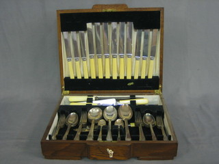 A canteen of silver plated flatware contained in an oak canteen box