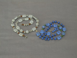 A string of grey Eastern hardstone beads decorated scarabs, together with a similar string of blue hardstone beads