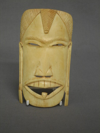 A carved ivory mask 6"