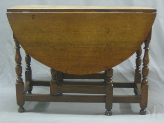An 18th Century honey oak oval drop flap gateleg dining table fitted a drawer, raised on turned and block supports 37"