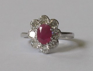 An 18ct white gold dress ring set a ruby surrounded by diamonds approx 0.80ct