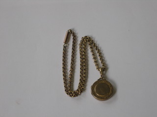 An engraved gilt metal locket hung on a box link chain