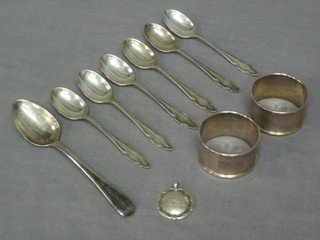 2 silver napkin rings, 6 silver coffee spoons, a Georgian silver spoon and a silver watch chain medallion 4 ozs