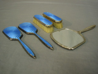 An Art Deco 5 piece silver and blue enamel backed dressing table set comprising hand mirror, pair of clothes brushes and pair of hair brushes (minus bristles)