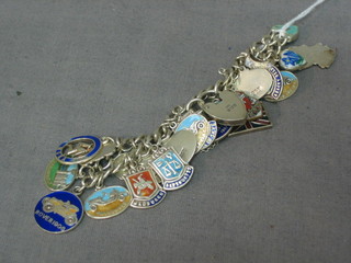 A lady's curb link bracelet hung numerous charms