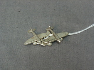 A pair of silver cufflinks in the form of a spitfire