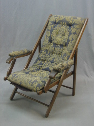 A 19th Century folding campaign armchair upholstered in blue material